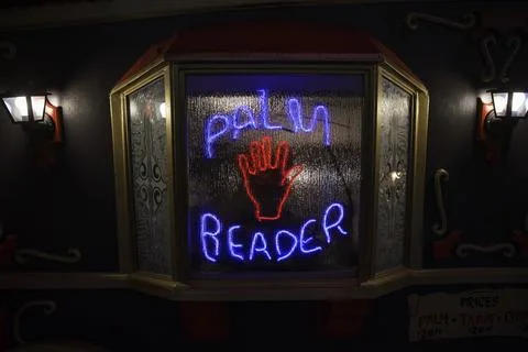 Neon palm reader sign on caravan window Stock Photos