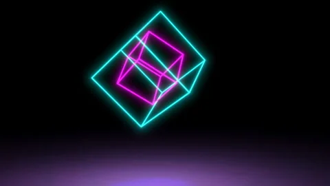 A neon pink cube rotates inside a blue cube against a dark background. Seamless Stock Footage 122048802