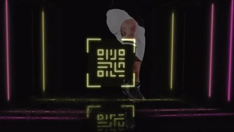 Neon qr code over mid section of male soccer player kicking the ball against Stock Footage 330473779