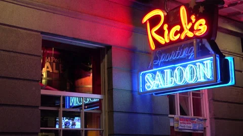 Neon sign for Rick's Saloon on Bourbon Street in New Orleans at night and legs 스톡 동영상 66548559