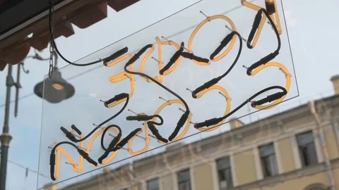 Neon sign seen from inside a bar at dusk Stock Footage 115501745