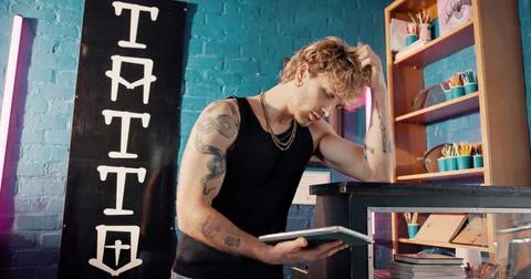 Neon, tablet and thinking with man in tattoo parlor for artistic design or .. Stock Photos