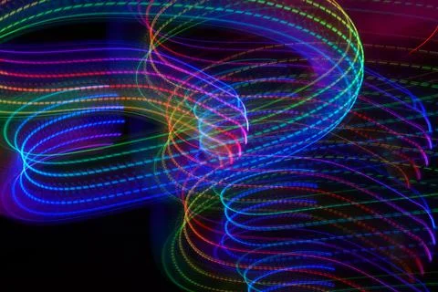 Neon wave pattern. Abstract lines isolated on a black background. Luminous Stock Photos