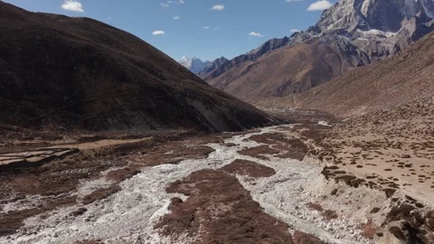 Nepal Aerials View of a Mountain Valley with a Rocky Riverbed and High Peaks 库存影片 330979737