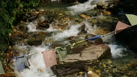 Nepal Buddhist Prayer Flags and a River, River Flowing and Lush Green Scenery Stock Footage 339768982
