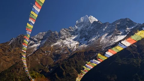 Nepal. Colorful flags with Buddhist scriptures are waving in the strong wind Stock-Footage 114065175