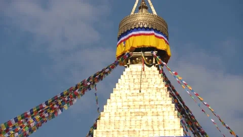 Nepal. Pan from sky of Buddhas blue eyes and buddhist prayer flags. Video stock 140438463