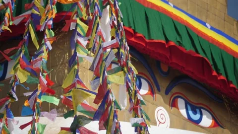 Nepal. Side view of Buddhas blue eyes and buddhist prayer flags. 스톡 동영상 140437722