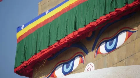 Nepal. Side view of Buddhas eyes and buddhist prayer flags with sky. Video stock 140438087