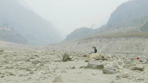 Nepalese guide has a rest on the stone. Manaslu circuit trek. Video stock 91330507