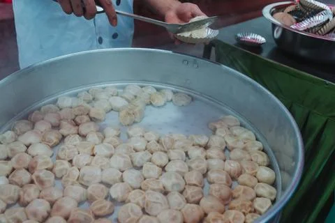 Nepalese steamed dumpling momo serving at the party. Close up image. Stock Photos