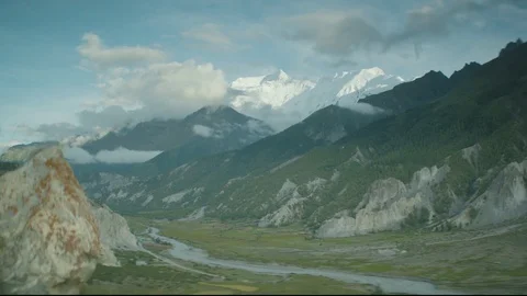 Nepalese Valley with river and big mountains in the background Stock Footage