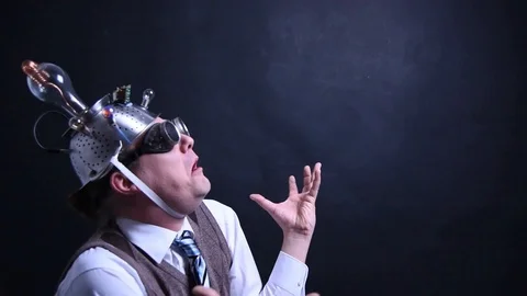 Nerd with aluminum hat is looking to the sky above Stock Footage 104306244
