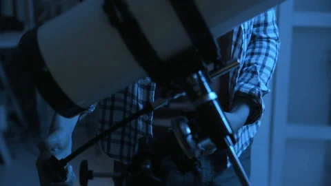 Nerd boy looking through a telescope and exploring constellations Stock Footage 128500722