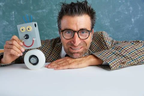 Nerd electronics technician with self made robot Stock Photos