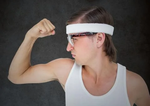 Nerd flexing against grey grunge wall Stock Photos