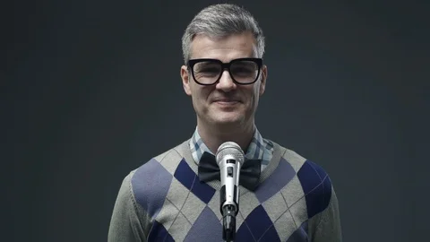 Nerd guy adjusting the microphone before giving a speech Video stock 90641994