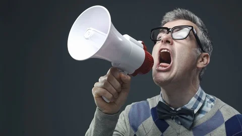 Nerd guy shouting a message using a megaphone Video stock 90642448