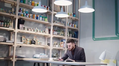 Nerd hipster guy sitting at bar table and using a phone Video stock 57112436