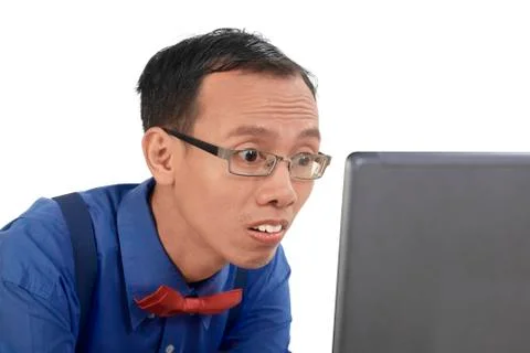 Nerd man using laptop and look concentration using laptop Stock Photos