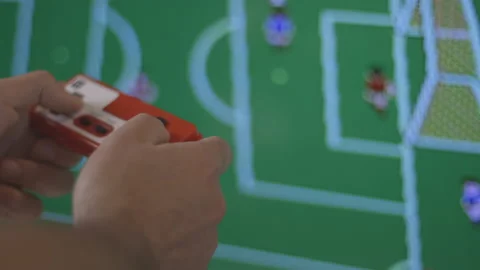 Nerd plays with red retro soccer video game. Male game player. Hands close up Stock Footage 154208928