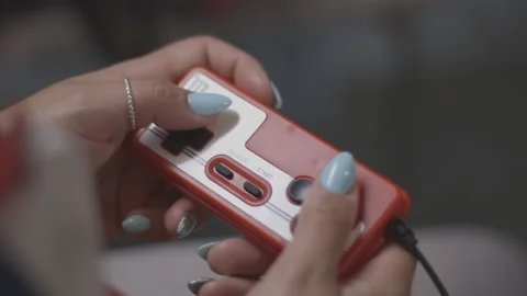 Nerd plays with red retro video game. Female game player. Hands close up Stock Footage 154209058