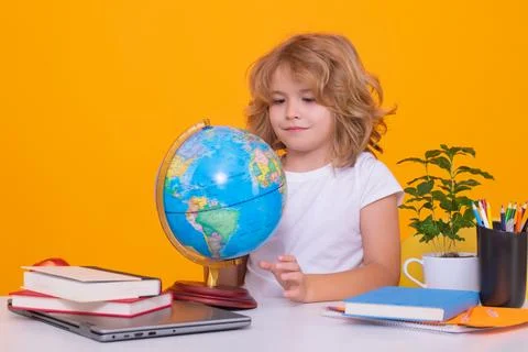 Nerd pupil boy from elementary school with book isolated on yellow studio Foto stock