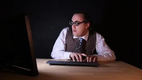 Nerd is sitting at the PC and typing Stock-Footage 104332803
