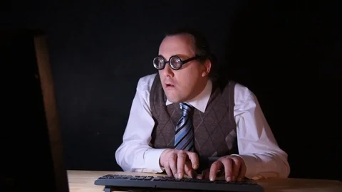 Nerd is sitting at the PC and typing Stock-Footage 104351531
