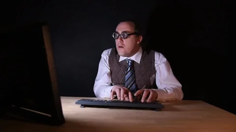 Nerd is sitting at the PC and typing Stock-Footage 104353369