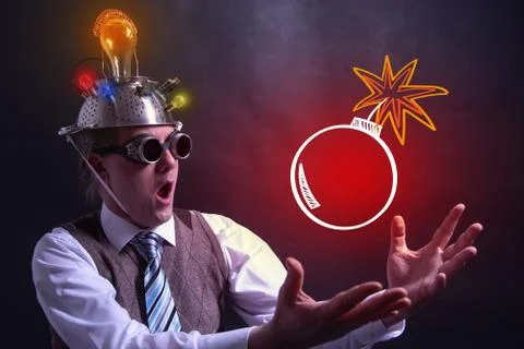 Nerd with tin foil hat presenting bomb symbol Stock Photos