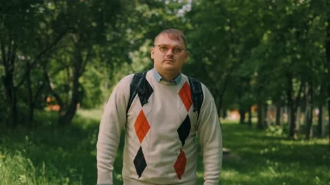 Nerdy fat guy is walking to school. Concept of loser nerd at university. Video stock 143380054