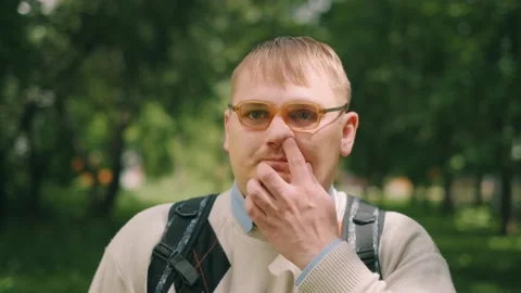 Nerdy fat guy is walking to school. Concept of loser nerd at university. Close Video stock 143380417