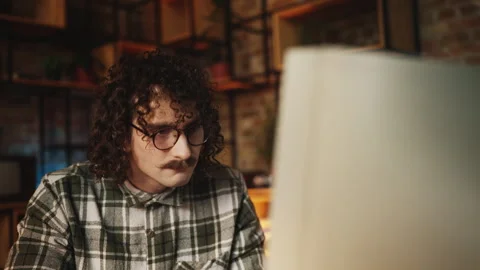 Nerdy guy frustrated with computer software error in 90s office lifestyle Stock Footage 315456529