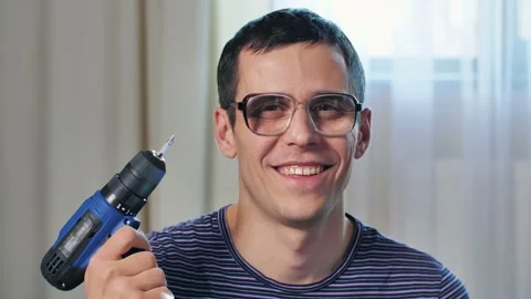 Nerdy man with screwdriver at home Stock Footage 146462783