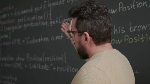 Nerdy Young Male Programming Teacher Explaining Algorithm on Blackboard Vídeo Stock 318710939