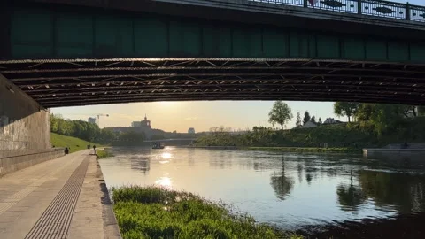 Neris river embankment in evening in spring. Vilnius, Lithuania Stock Footage 241210385