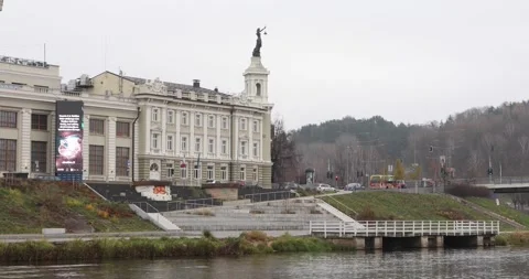 Neris riverside view with historic Vilnius building and passing traffic Stock Footage 321049852