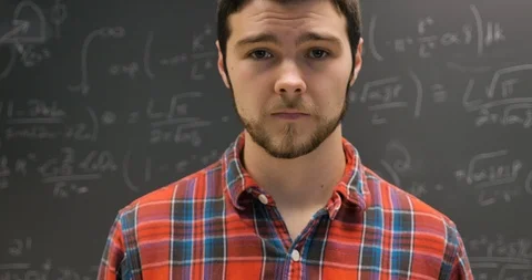 Nervous anxious young man twitching in front of a complex math problem Stock Footage 106076565