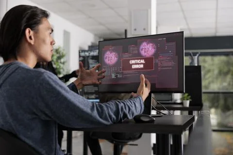 Nervous app developer having system error message on computer screen Foto stock