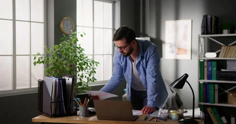 Nervous businessman analyzing documents doing paperwork, looking worried and Video stock 151350257