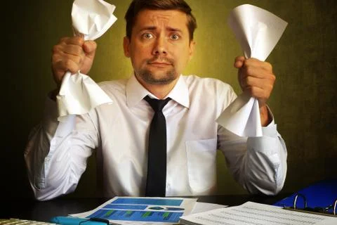 Nervous businessman observing bills. Problems in a business. Stock Photos