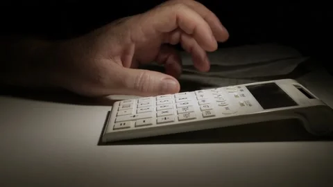 Nervous Businessman Working Late, with an Adding Machine. Stock Footage 160319046
