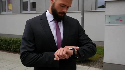 Nervous bussinessman checking time while waiting for a meeting. Outdoor photo Stock Footage 56526563