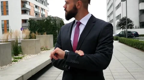 Nervous bussinessman checking time while waiting for a meeting. Outdoor photo. Stock Footage 60944801