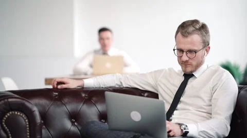 Nervous concerned office worker sit on couch with laptop look at screen and Stock Footage 133221415