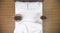 The nervous couple sit in the bed. view from above 4k or 4k+ Resolution