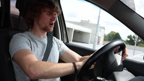 Nervous driver shouts and raises his hands in frustration while driving Stock Footage 343720157
