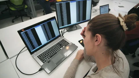 Nervous female programmer looking at her code on computer screen, trying to s Video stock 166058858