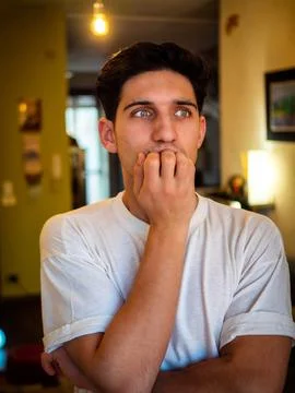 Nervous guy looking away alone at home Stock Photos